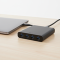 7-port USB-C hub on a desk next to a laptop